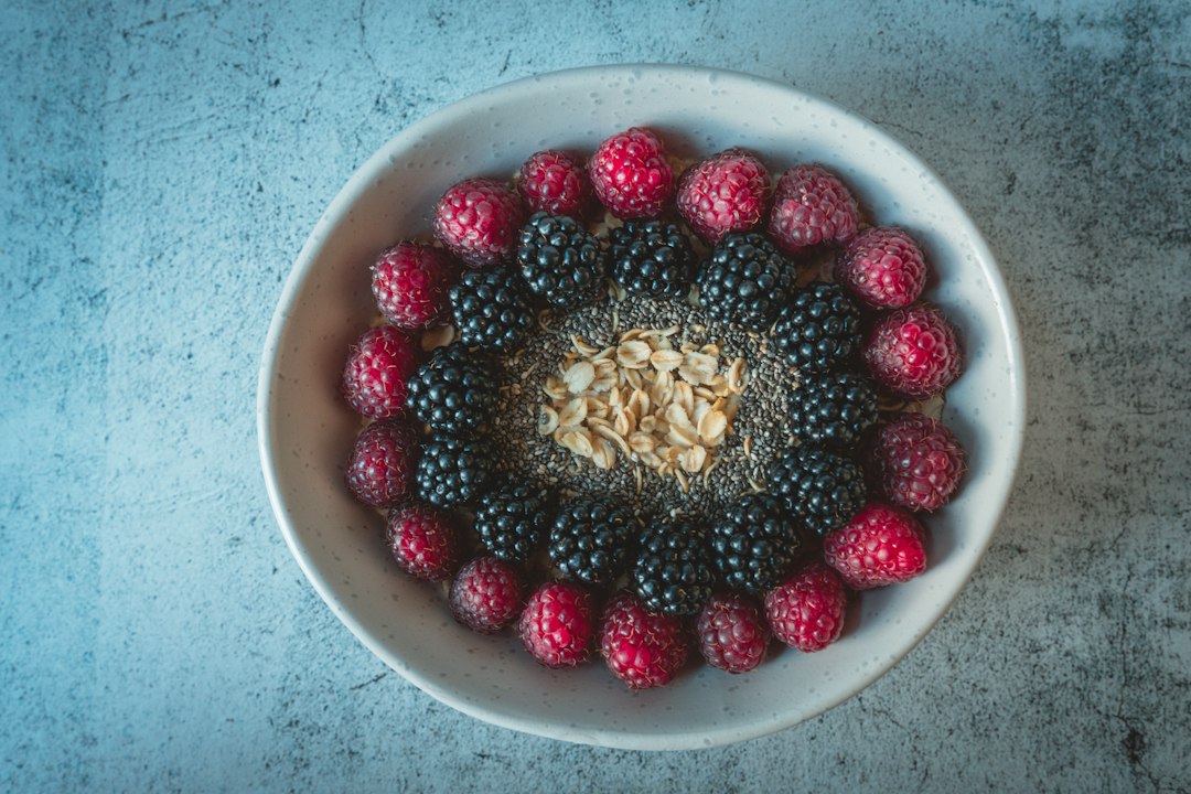 A bowl of oats with raspberries and blackberries