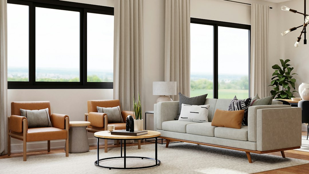 A bright living room with large windows and a sofa