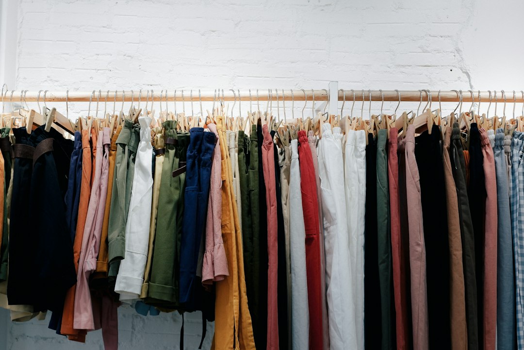 A rack of clothing arranged by color