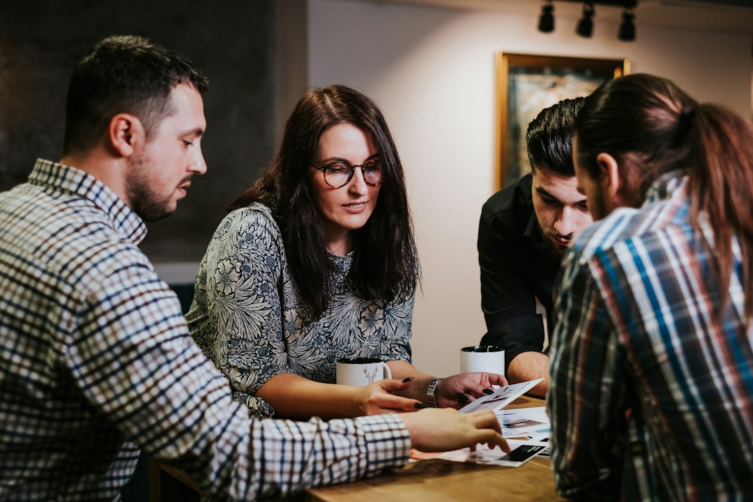 A team reviewing documents together at a wooden table