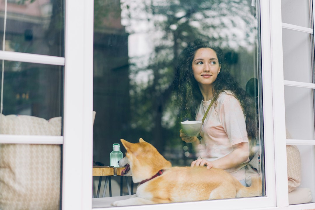 A woman sitting at a cafe with a dog