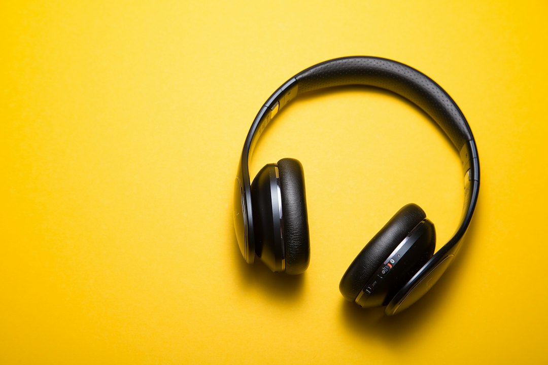 Black over-ear headphones on a yellow surface