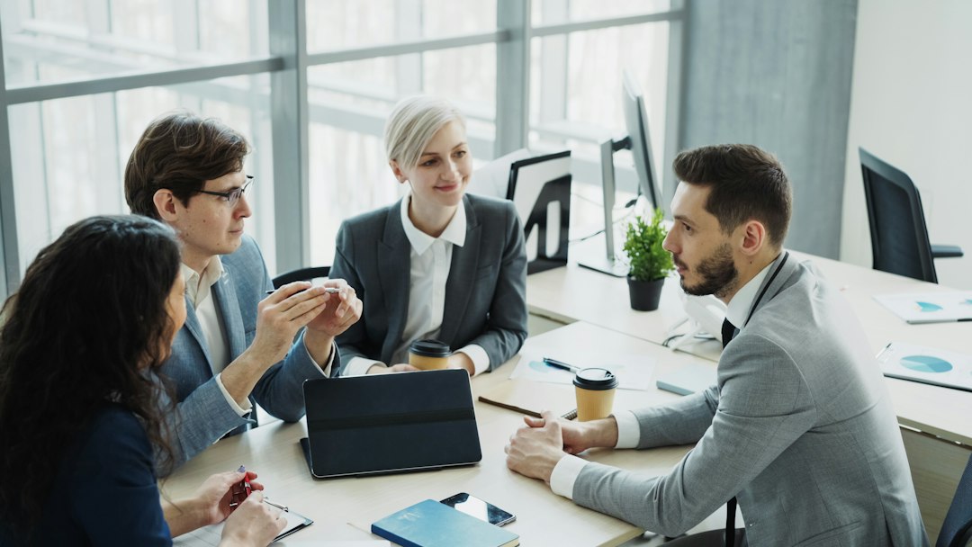 Colleagues discussing a project around an office table