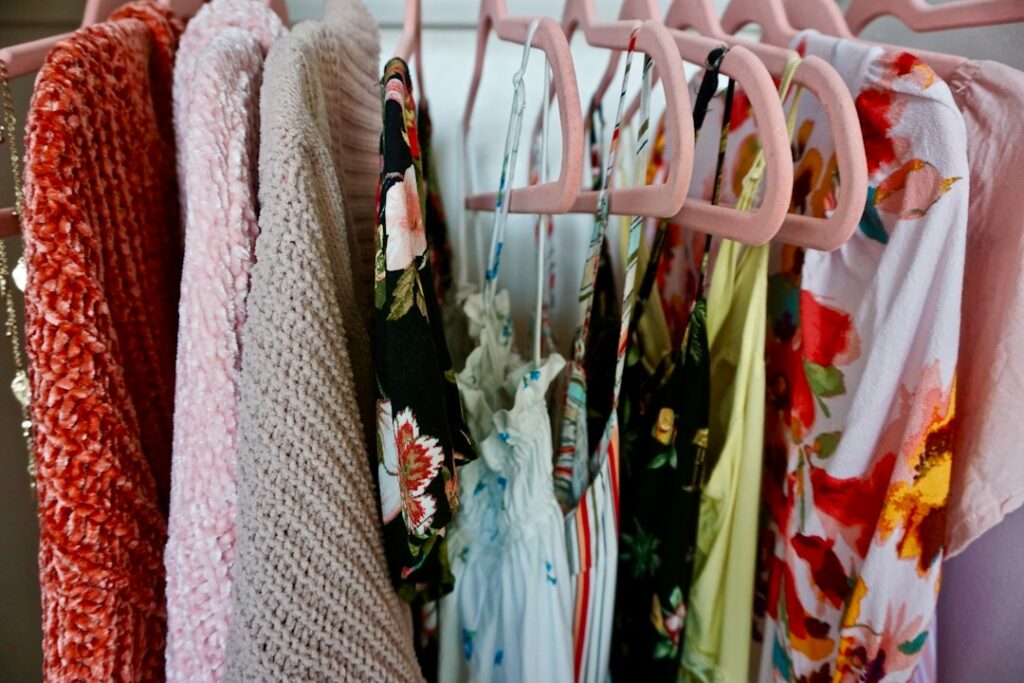 Floral dresses and light clothing on a rail