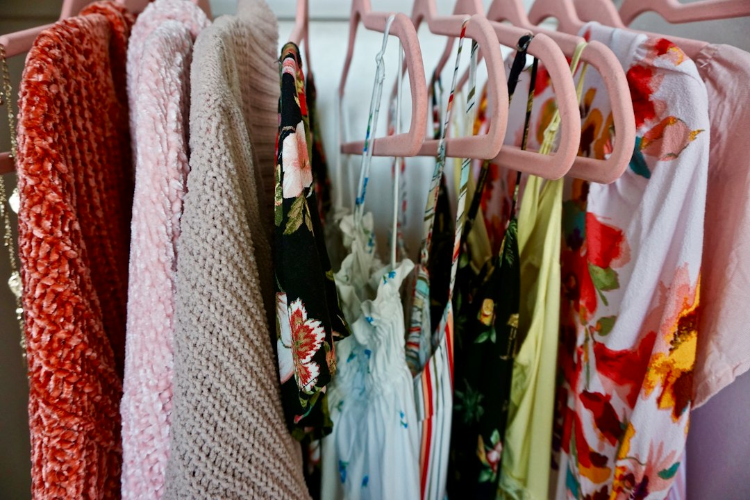 Floral dresses and light clothing on a rail