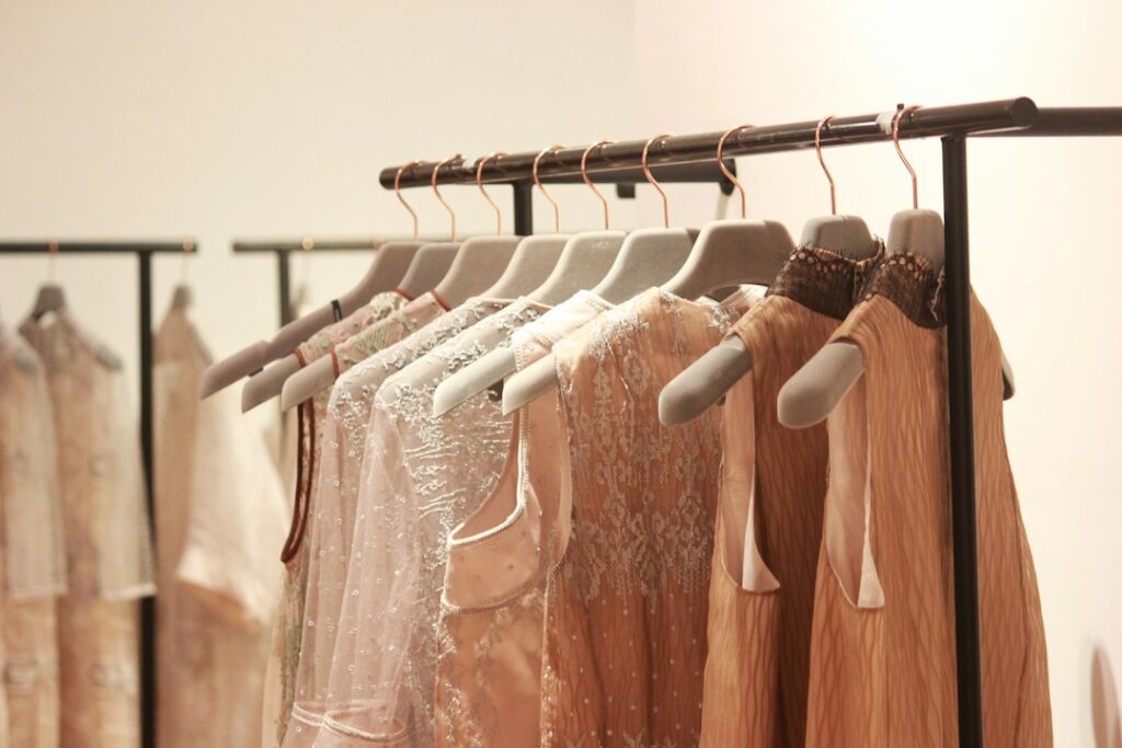 Light-colored dresses displayed in a boutique
