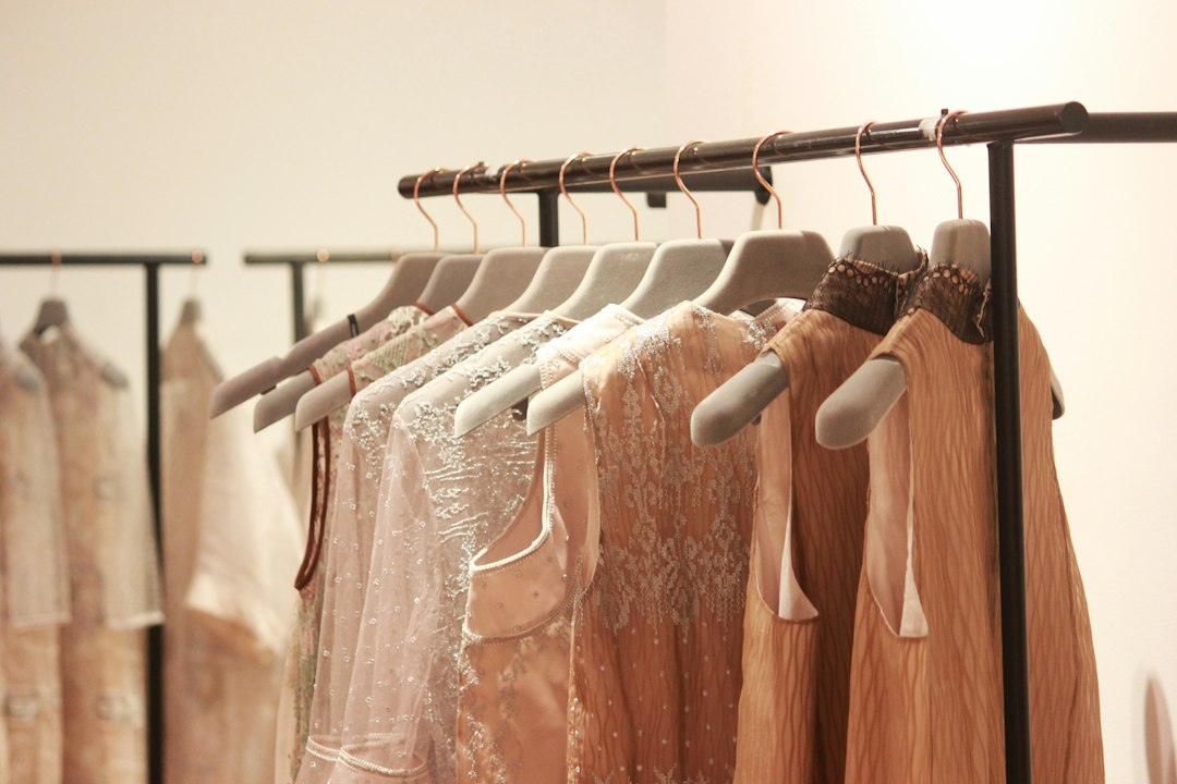 Light-colored dresses displayed in a boutique