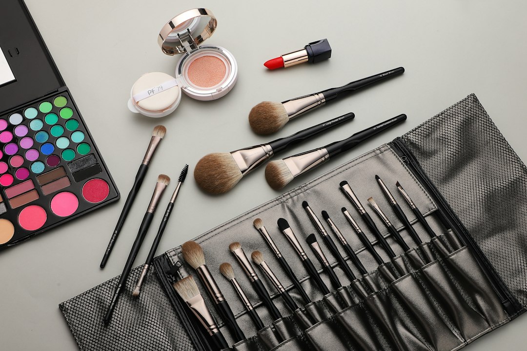 Makeup brushes, eyeshadow and cosmetics arranged on a table