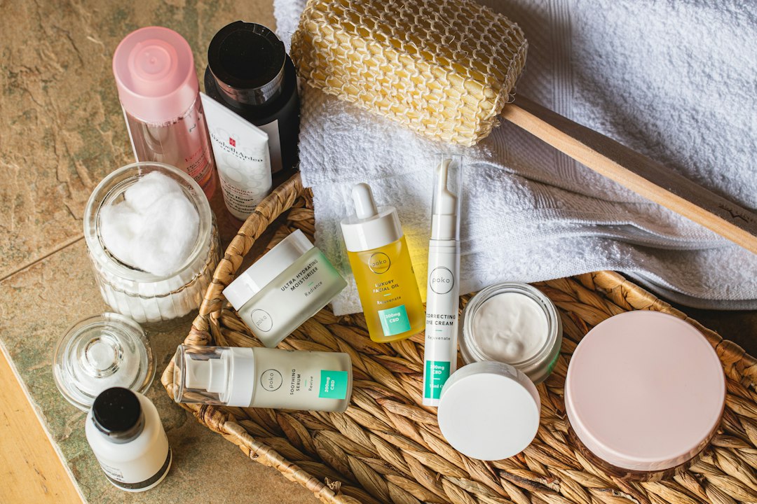 Skincare jars, bottles and a body brush in a woven tray