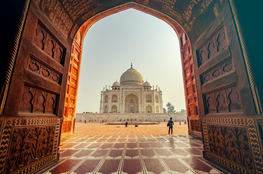 The Taj Mahal seen through a stone archway